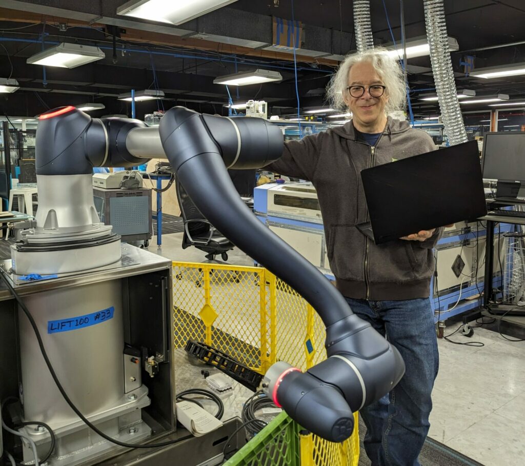 A robot geek and his robot arm.